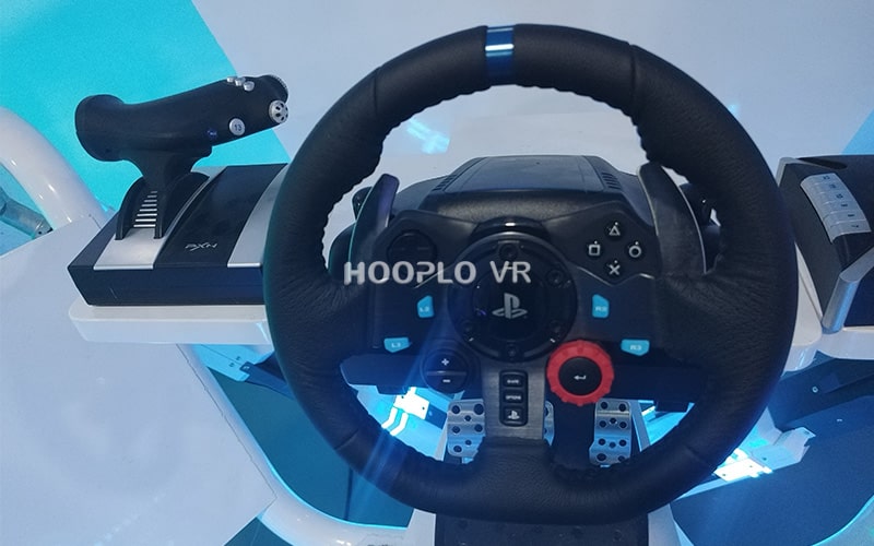 Close-up image of the steering wheel section of the VR Six-Axis Racing Simulator taken in the Hooplo showroom to highlight professional driving controls.