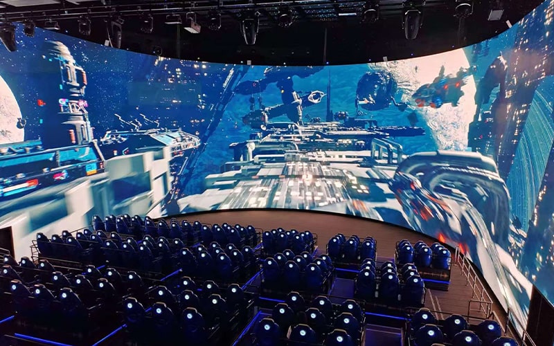 Interactive 5D cinema theater featuring motion seats and immersive effects combined with on-screen gameplay elements.