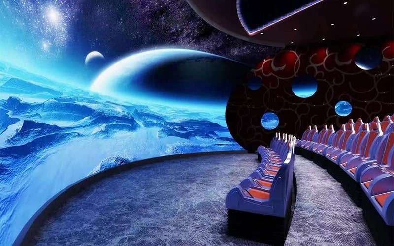 Audience using shooting controllers inside a 5D cinema, demonstrating how interactive gameplay is integrated with movie scenes.