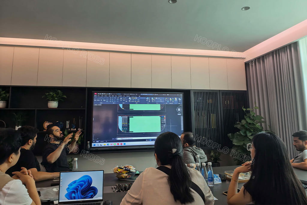 Hooplo design & sales team hold meeting with Uzbekistan 5-member client group, review CAD layout drawing for new full-floor indoor family entertainment center project